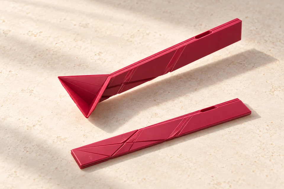 Two red Polygons measuring spoons, one folded and one flat